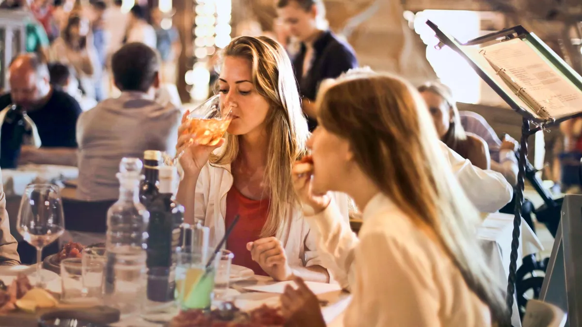 A group of friends sharing a relaxed dinner together at a restaurant table