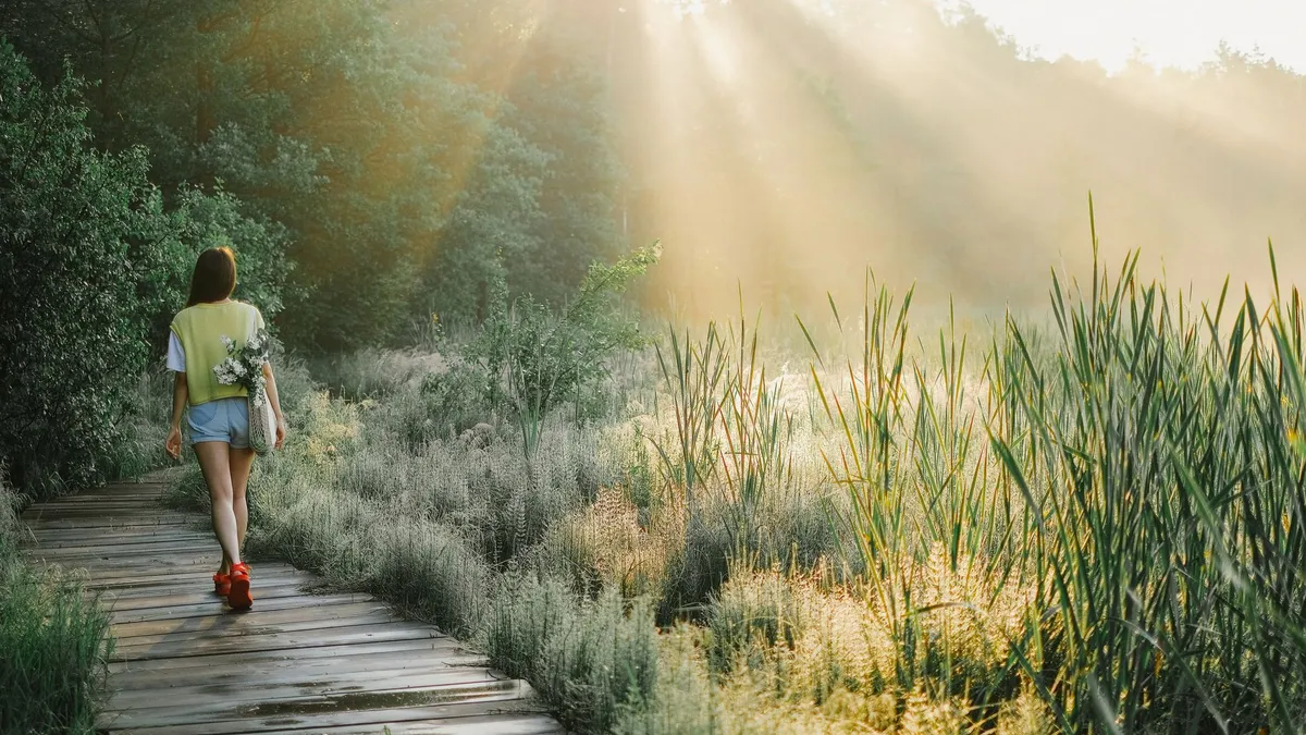 A person walking outdoors in daylight for everyday activity