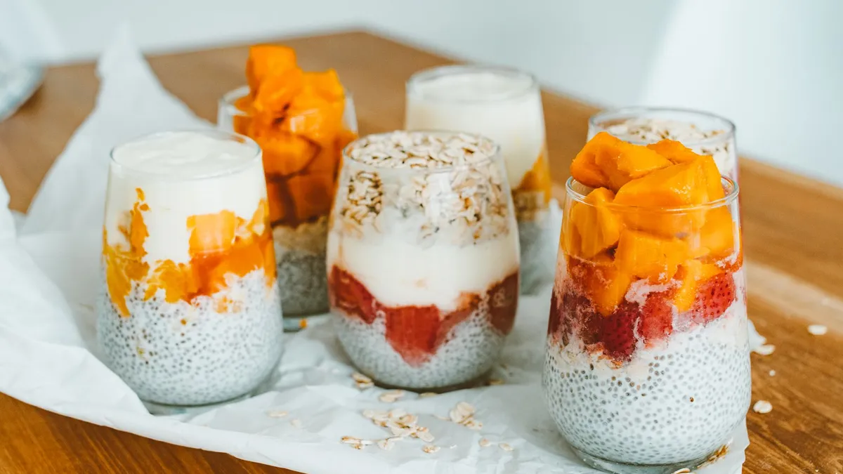 A jar of overnight oats topped with peanut butter and berries on a kitchen counter