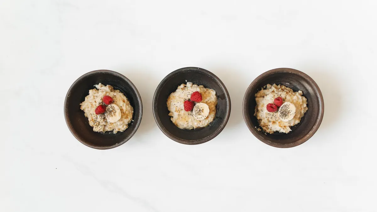 Home-cooked meal portioned into bowls with vegetables and grains on a kitchen counter