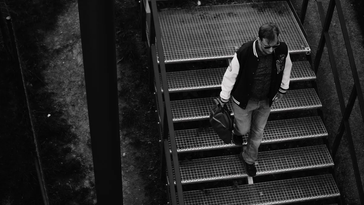 Someone climbing a staircase instead of taking the lift