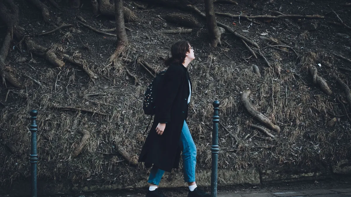 A person walking briskly outdoors, showing everyday non-exercise activity